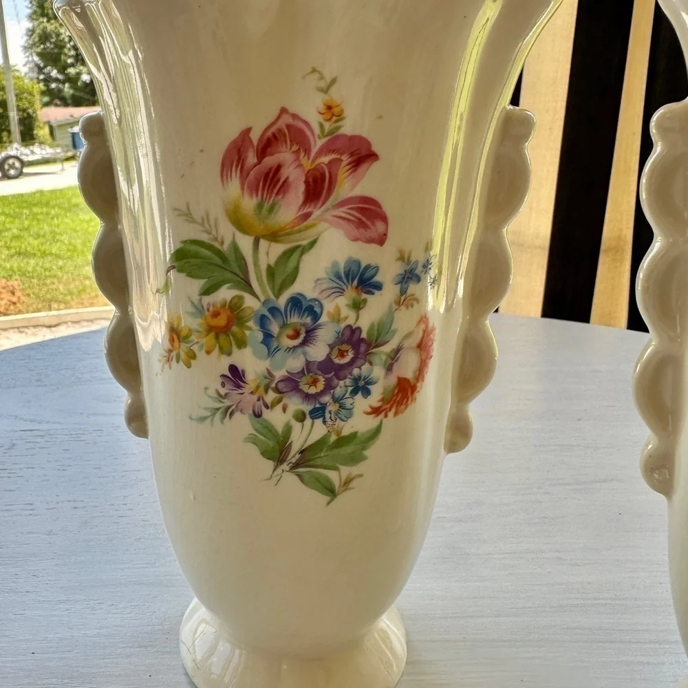 1950’S SET/2 , FLORAL VASES. SOFT CREAM COLOR WITH ONE SIDED FLORAL DESIGN.
